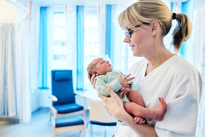 Midwife holding baby