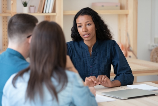 Coordinator in conversation with a young couple