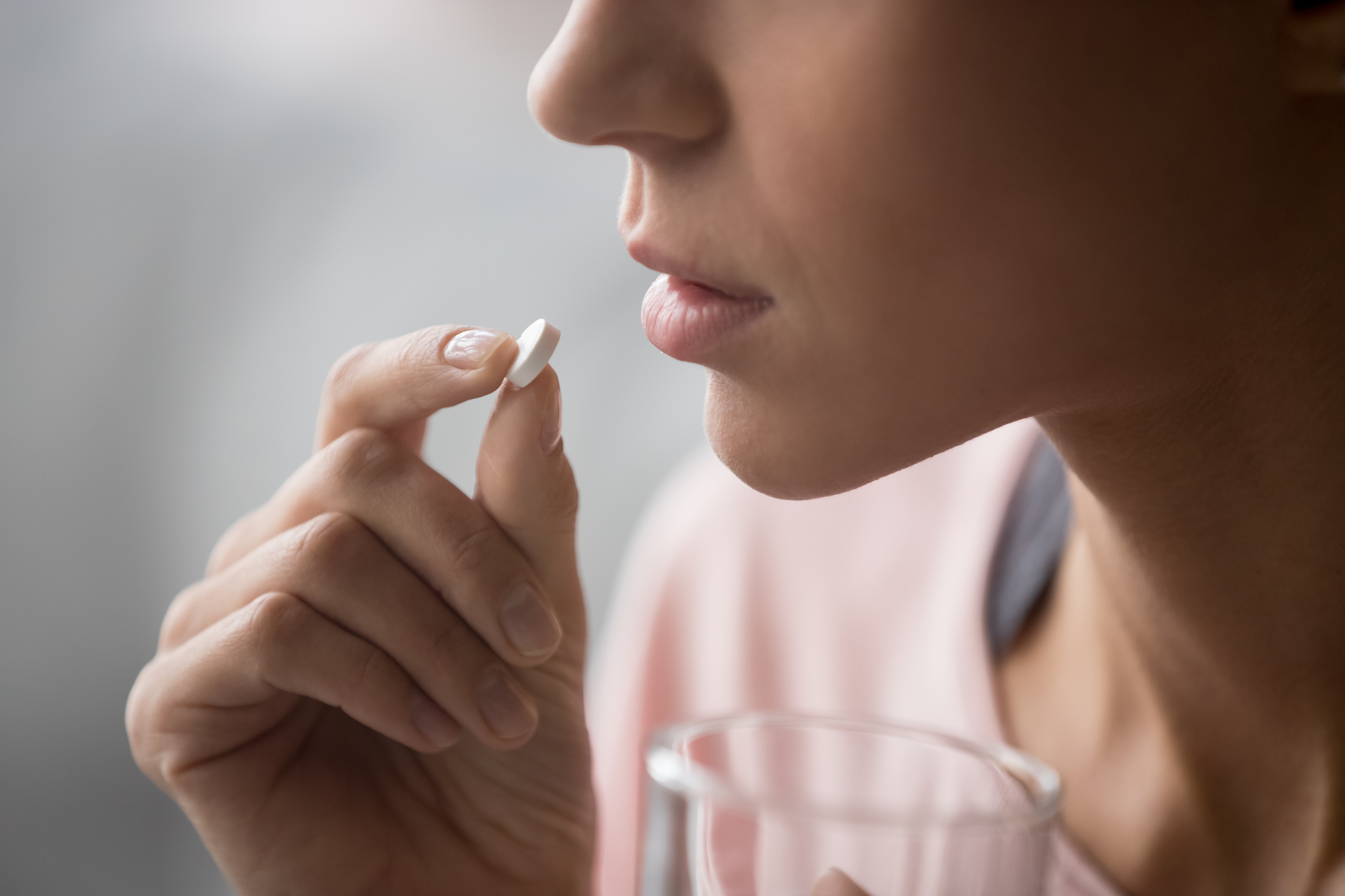 A woman taking a pill