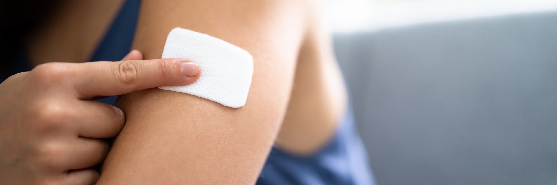 Contraceptive patch on a woman's shoulder