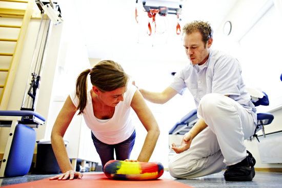 A therapist shows a woman exercises