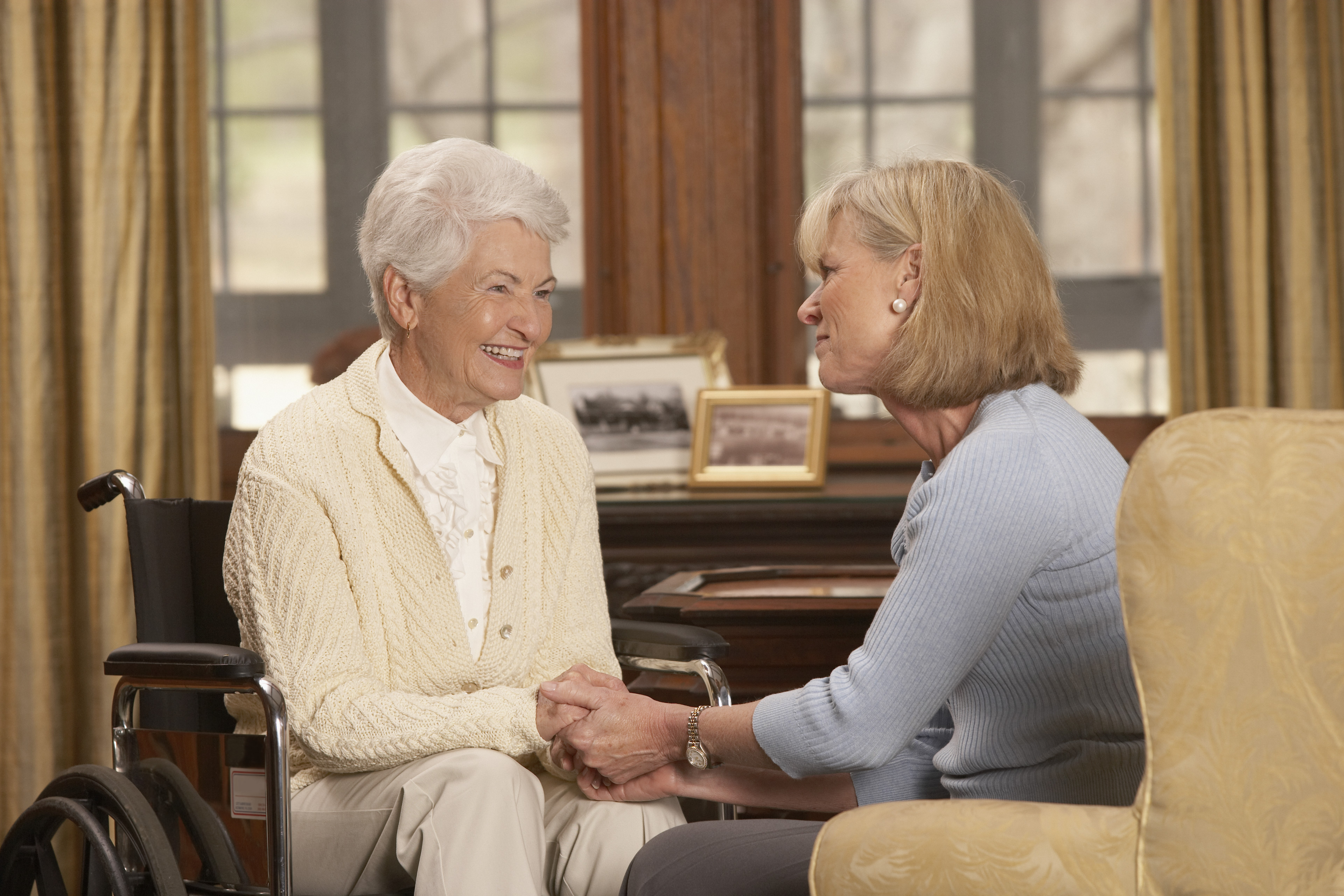 Older woman sitting together with her daughter