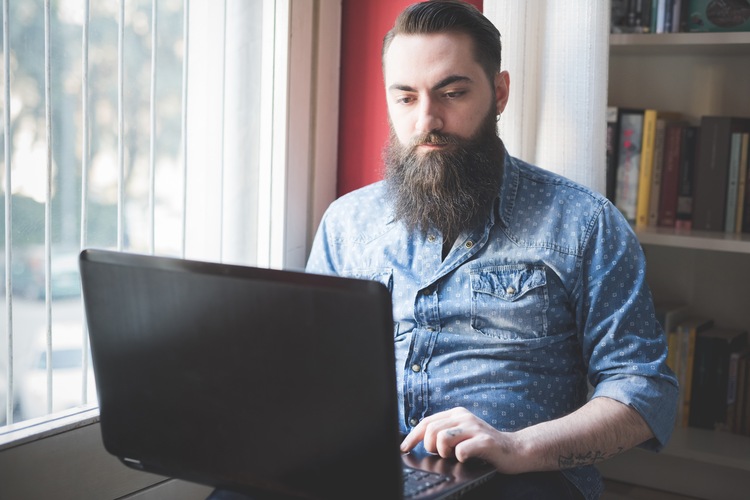 A man submitting a complaint on a computer