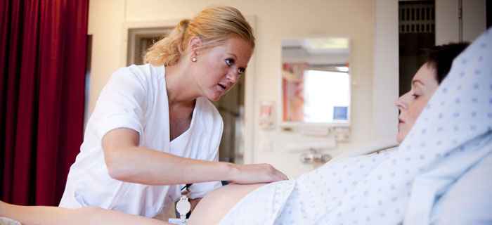 Nokre gonger må fødselen settas i gang. Her sjekkar en sjukepleier ei gravid kvinne.