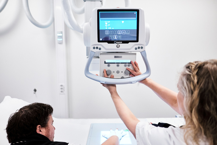 Nurse using X-ray machine