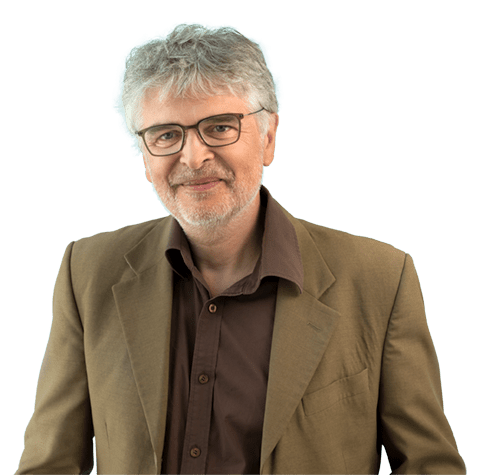Man with grey hair and glasses, wearing a green health worker t-shirt.