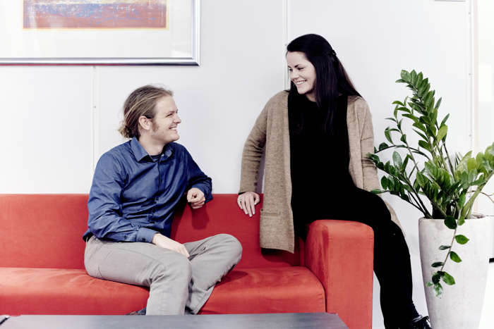 A young couple in a red sofa