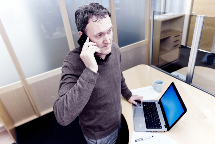 Man in office talking on the phone