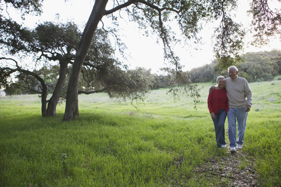 An older couple walking in nature