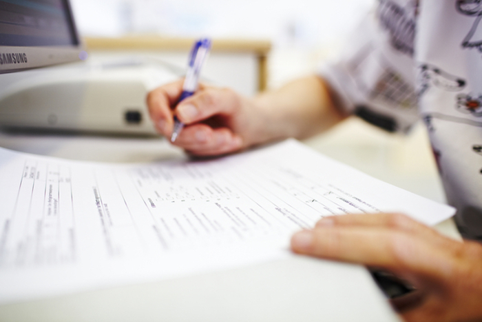 Person filling out a form
