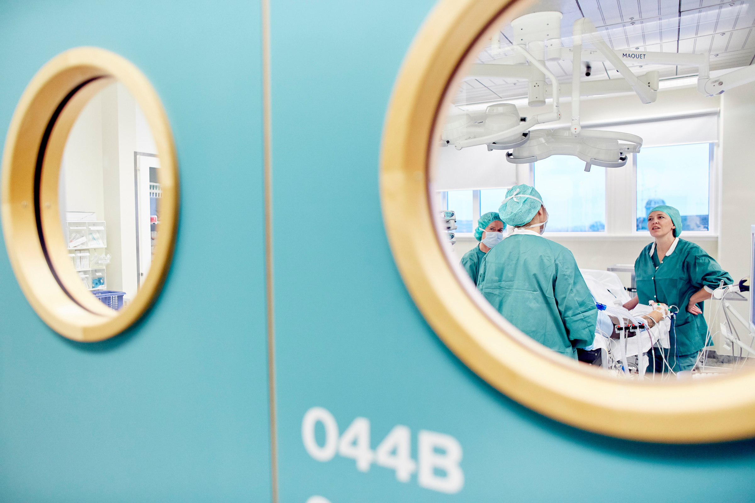 Looking through a round window into an operating theatre