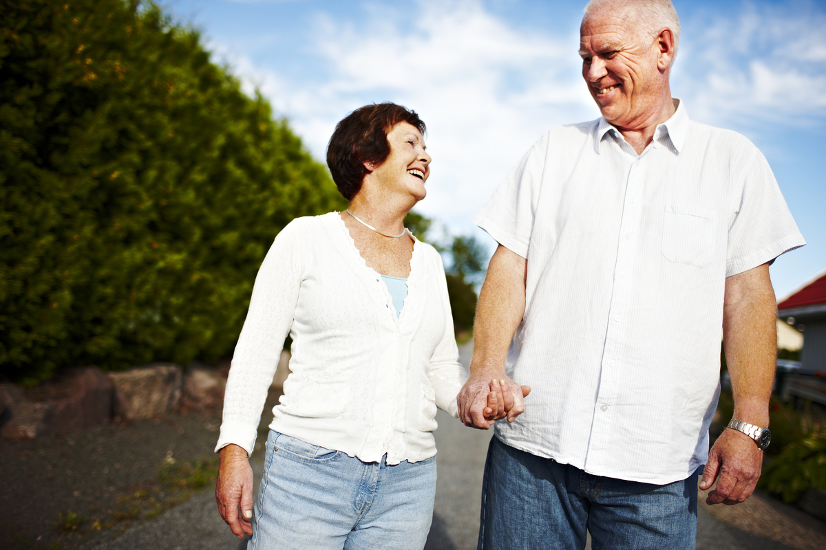 Smiling man and woman holding hands
