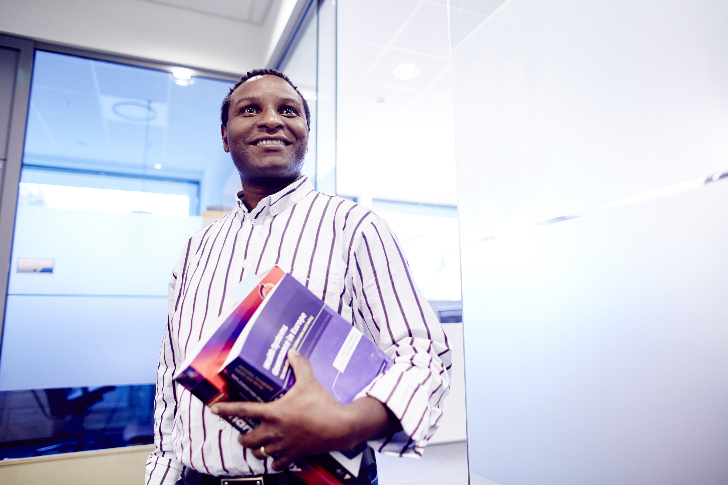Smiling man holding books
