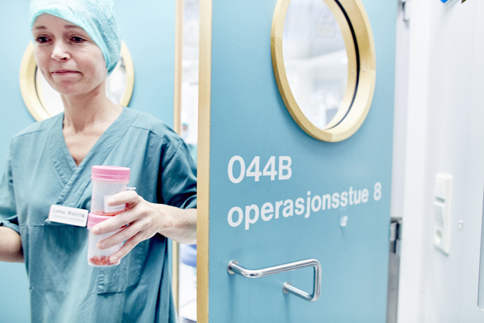 Health professional leaving the operating theater
