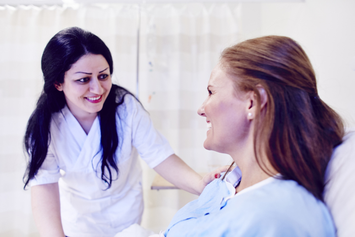 Nurse and patient smiling at each other