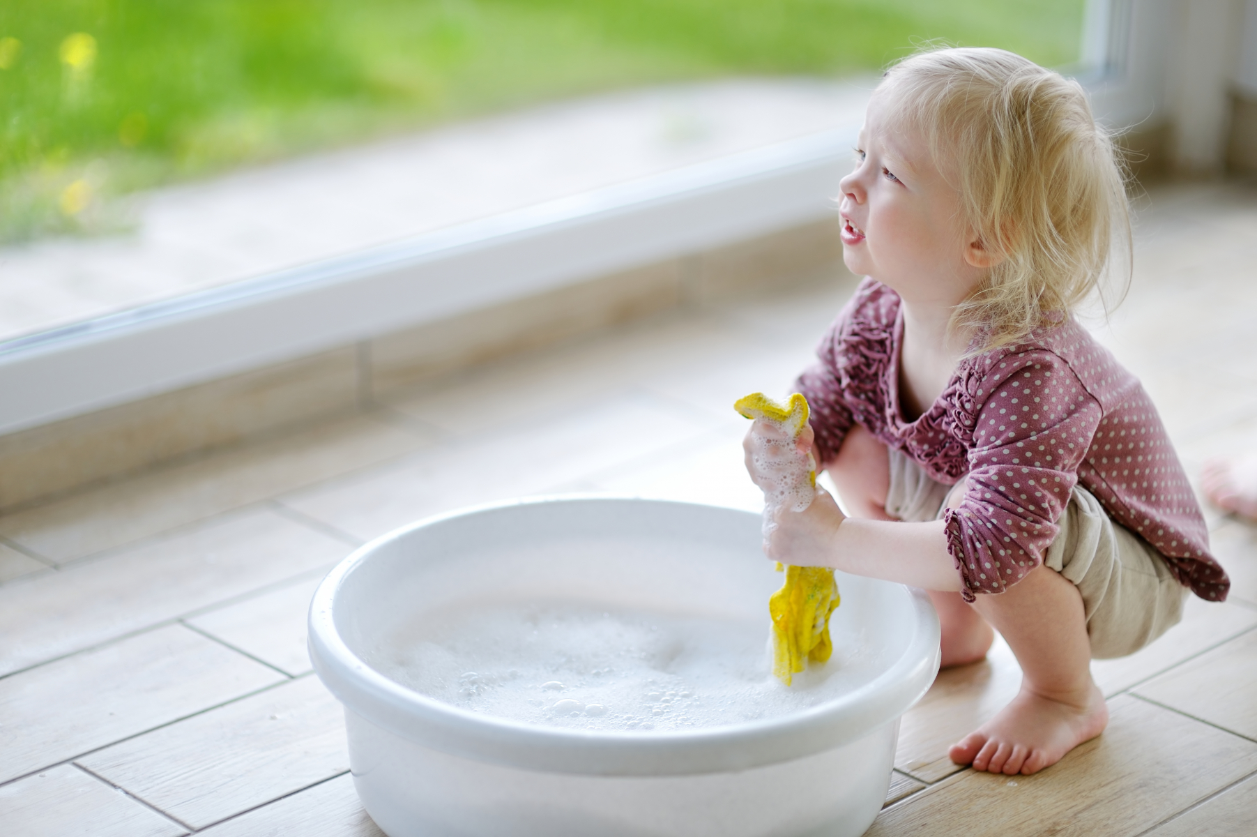 A child cleaning with a washcloth