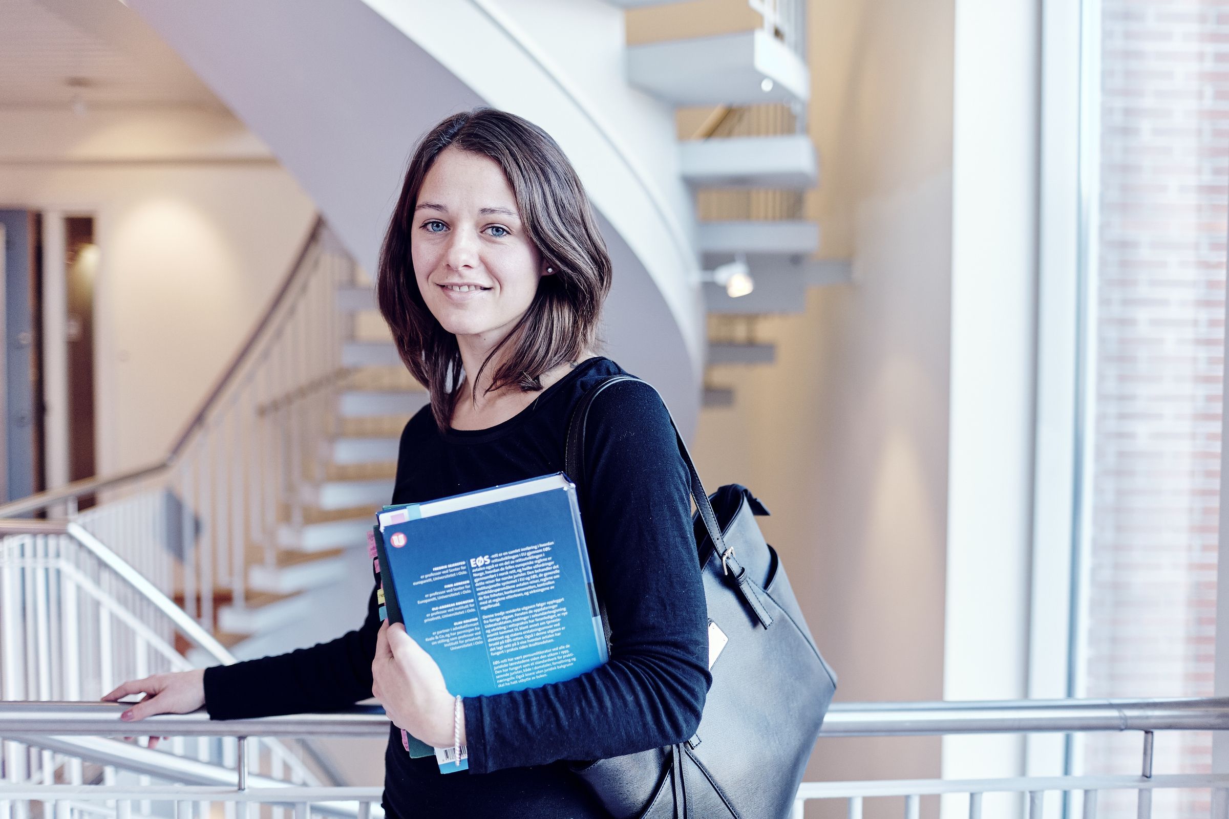 Young woman holding books